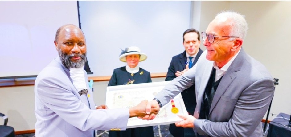 The Prophet receiving a presidential award plaque in Brazil.