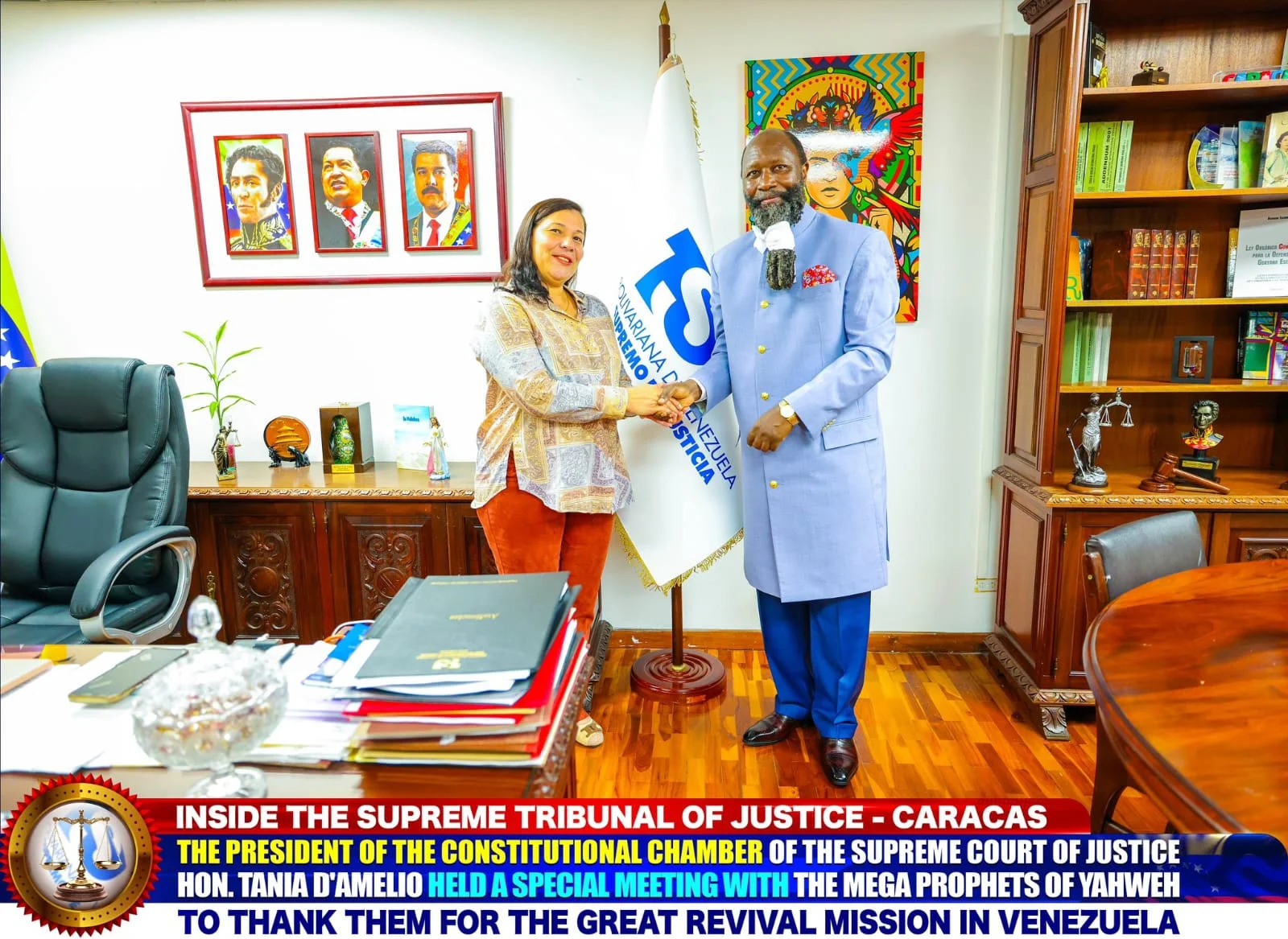 Hon. Tania D'Amelio shaking hands with the Prophet beside the Supreme Tribunal's flag, portraits of Bolívar, Chávez and Maduro on the wall.
