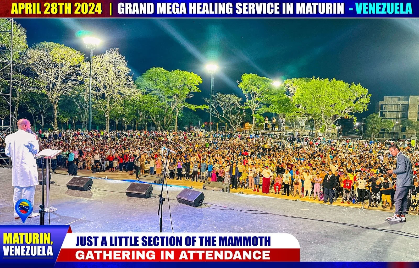 A vast night-time crowd in Maturín, seen from the stage, hands raised under floodlights.
