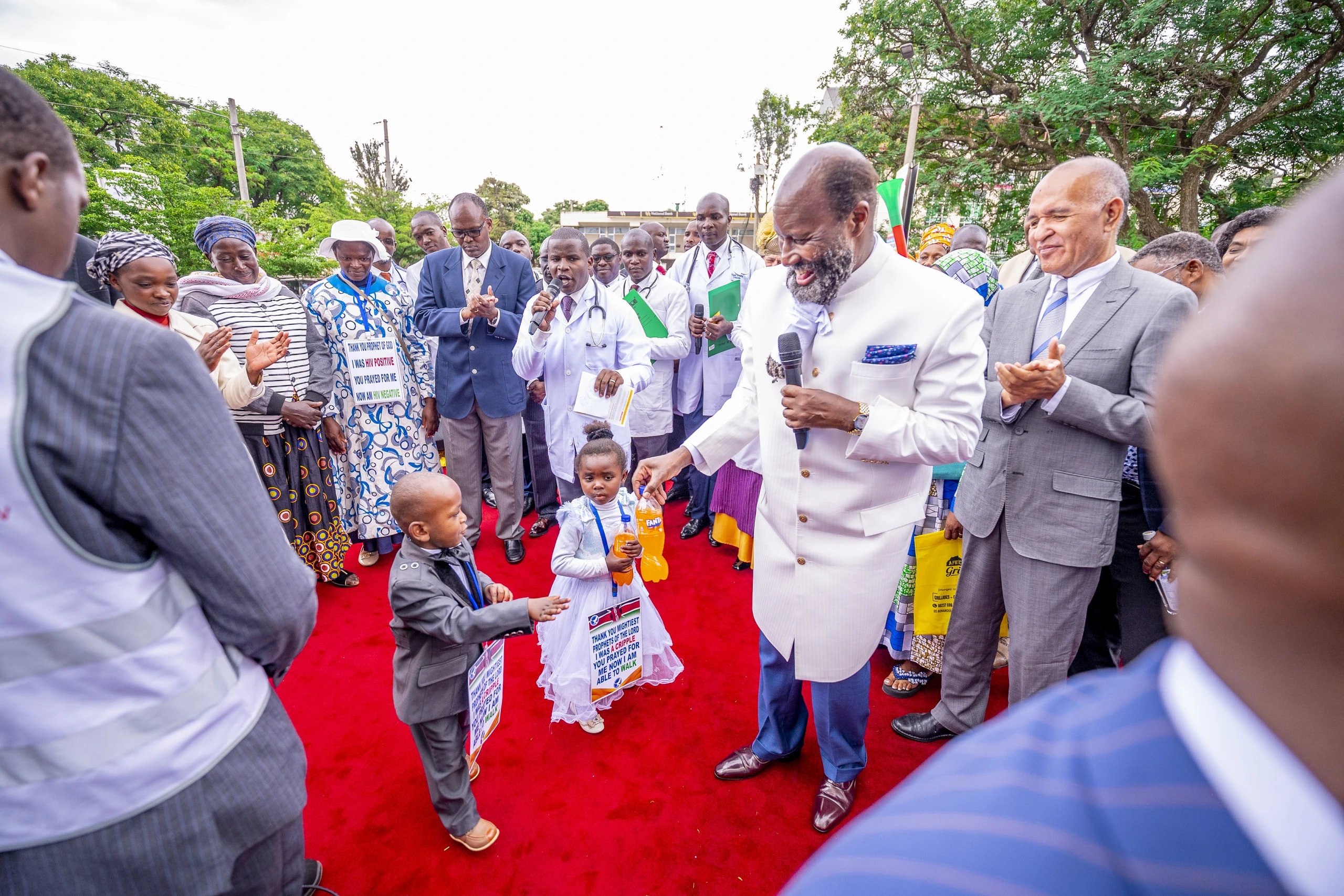 Children reaching out toward the Prophet in Nakuru.