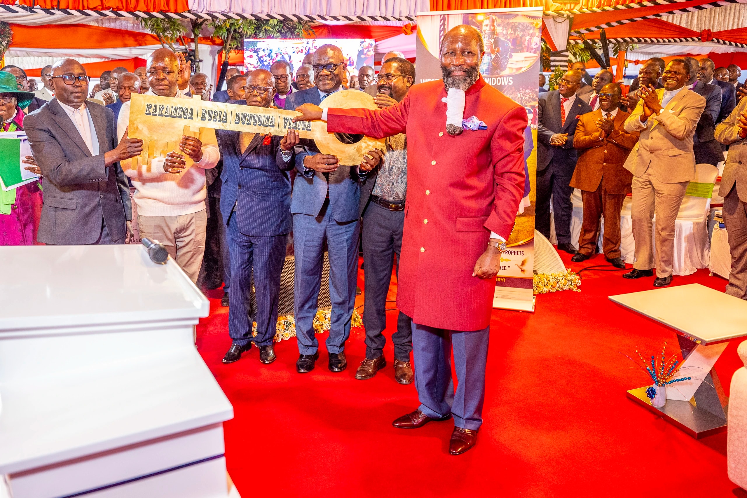 Leaders holding up a banner beside the preacher at the Western Region revival.